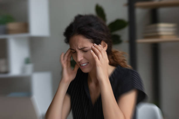 istock Unhappy stressed young woman suffering from headache. 1418467574