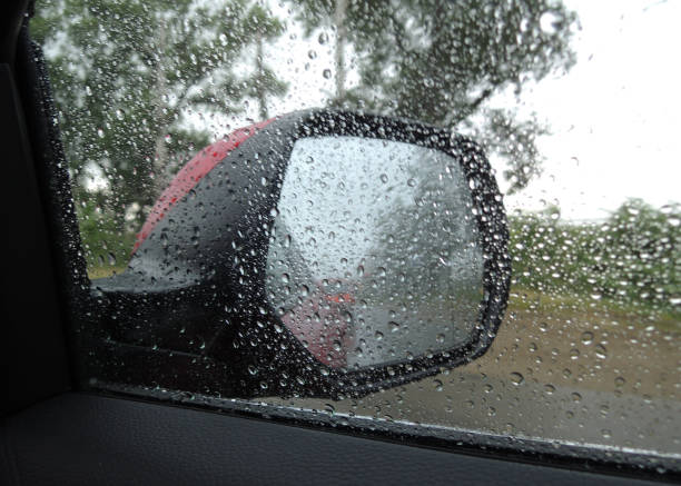 istock A rain drenched car side window makes it difficult to see in the rearview mirror 1418467796