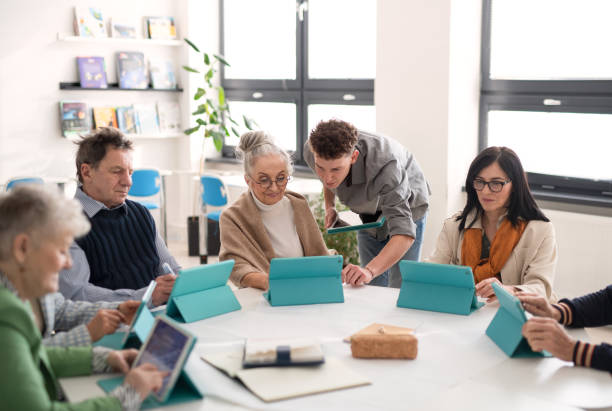 istock Group of seniors attending IT class in community centre with teacher 1418467967