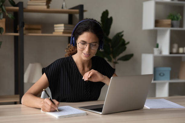 istock Happy interested millennial woman studying on online courses. 1418471393