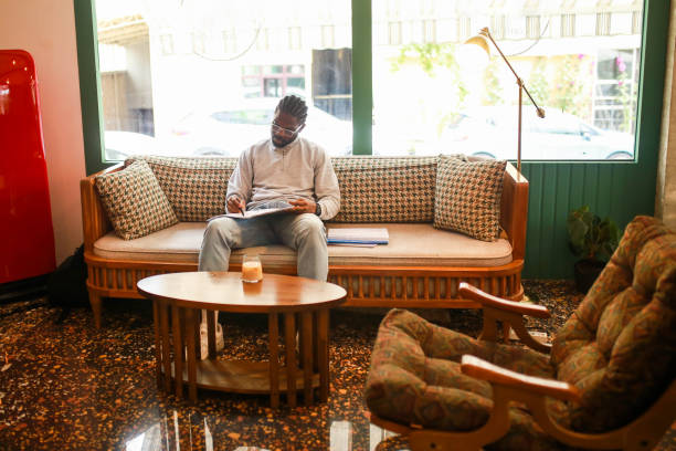istock black middle aged man studying in cafe and taking notes 1418473060