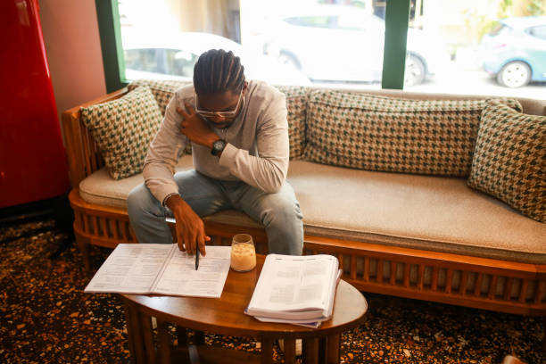 istock black middle aged man studying in cafe and taking notes 1418473154
