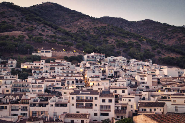 Mijas, Spain - August 20, 2022. Panoramic view of a white village, typical of the Costa Del Sol during sunset over the mountains of Andalusia.