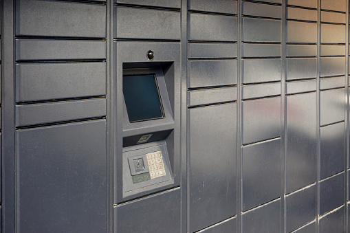 Close-up of a female hand opening a mailbox with a small key - post office box or PO BOX concept - bank deposit box