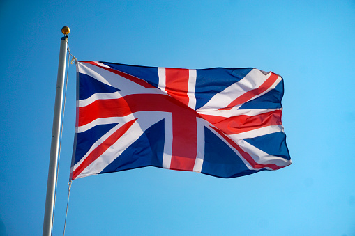 The flag of United Kingdom with realistic waving fabric effect.