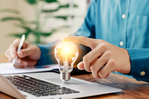 istock Successful Innovation through ideas and inspiration ideas. Human hand holding light bulb to illuminate, idea of creativity and inspiration concept of sustainable business development. 1418477006