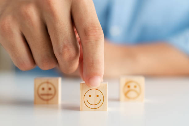 istock Customer satisfaction survey concept, customer hand selects wooden cube with smiley face icon, best service excellence rating for satisfaction. 1418478241