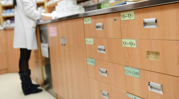 istock pharmacist taking medicine from drawer. 1418480392