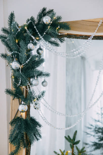 istock Decorated mirror and live Christmas tree with lights. New year's interior, festive atmosphere, decor, garlands, gifts. 1418481088