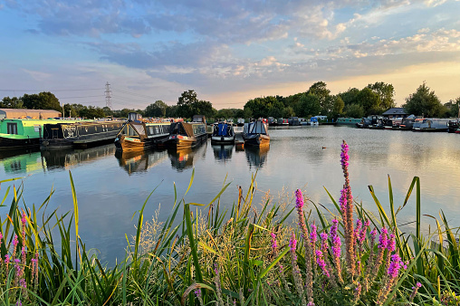 Lichfield, Staffordshire UK - Wide angle view of sunset and canal boats at King's Orchard Canal Marina on the Coventry Canal.