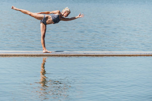 istock yoga exercises in nature practice outdoor 1418484045