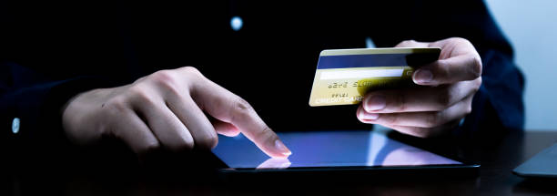 istock A person using a finger touchscreen on the tablet display for a commerce business pays online by credit card. 1418485332