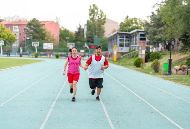 istock Young  athletes with Down syndrome running a track race 1418485737
