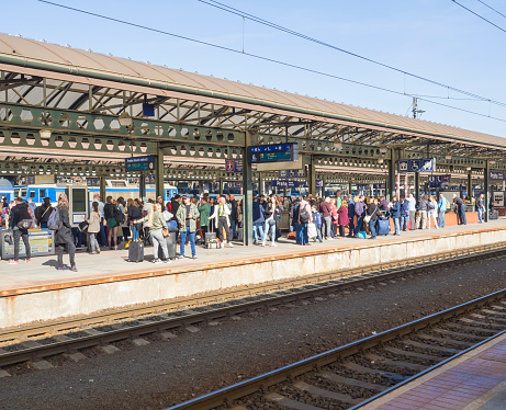Prague, Czech Republic, March 23, 2019: Crowd of People at the train platform are waiting for the train at the Prague main train station called Hlavni nadrazi, spring sunny day.