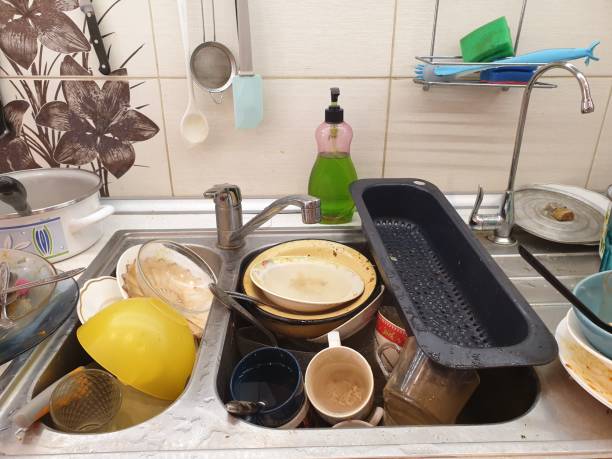 dirty and unwashed dishes in the kitchen sink. housecleaning. stock photo