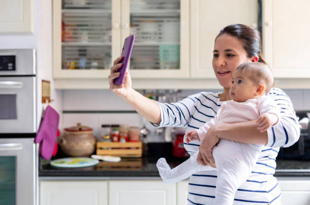 istock Happy mother at home taking a selfie with her daughter 1418487765