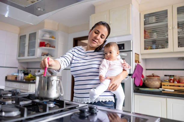 istock Busy mother multi-tasking at home 1418487792