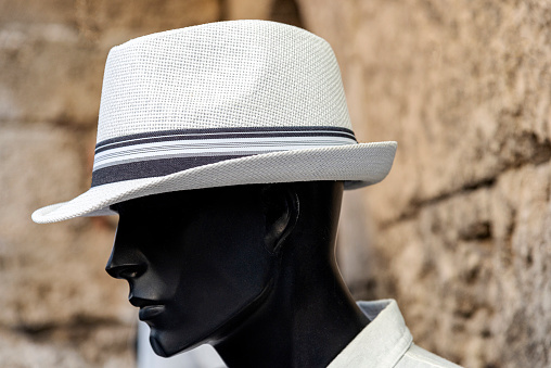 A white linen fedora on a black color man's mannequin head. in Rhodes, Greece.