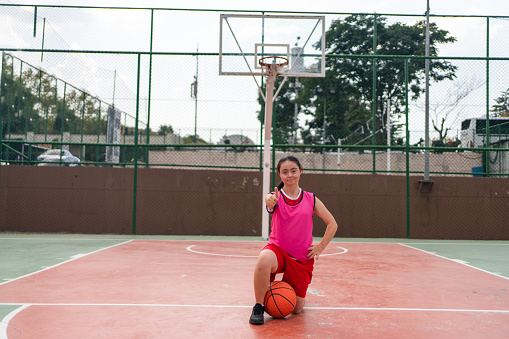 Young girl with down syndrome playing basketball