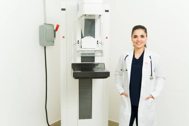 istock Beautiful smiling doctor or radiologist ready to do a mammogram test 1418492038