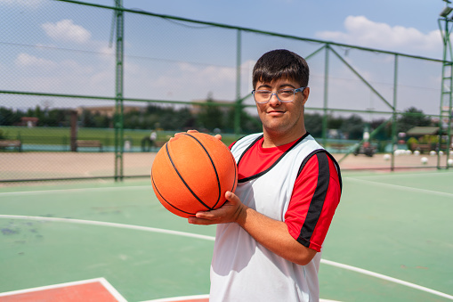 Teenage boy having a basketball training.