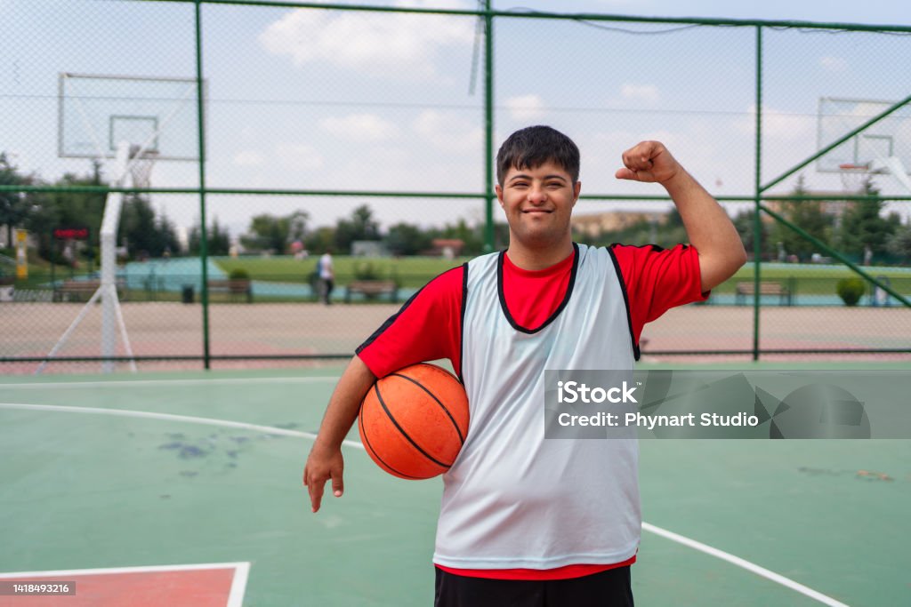 Young Man With Down Syndrome Playing Basketball Stock Photo - Download