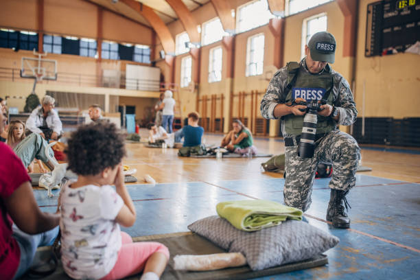 istock Army press with civilians after natural disaster 1418493340