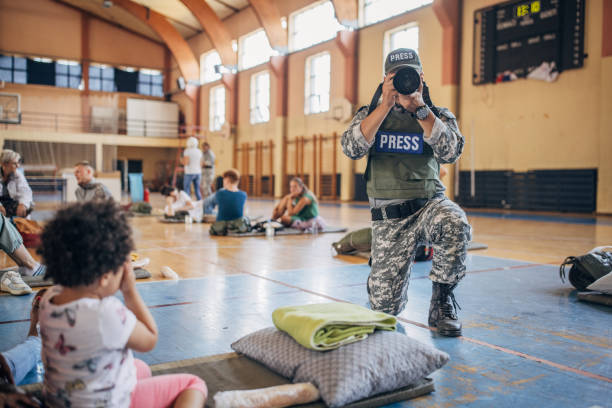 istock Army press with civilians after natural disaster 1418493382