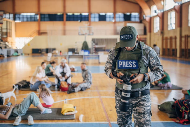 istock Army press with civilians after natural disaster 1418493410