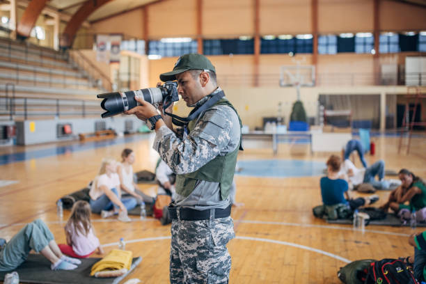 istock Army press with civilians after natural disaster 1418493468