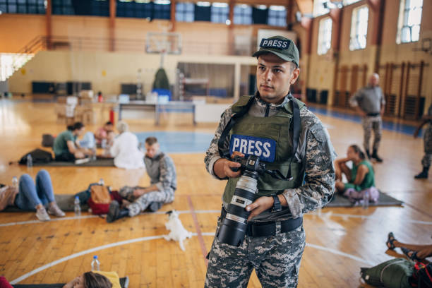 istock Army press with civilians after natural disaster 1418493758