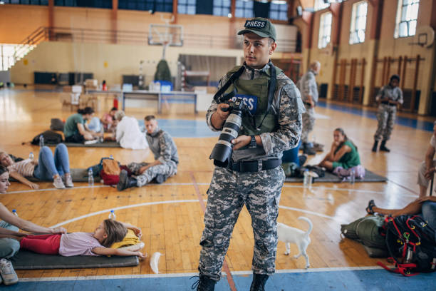 istock Army press with civilians after natural disaster 1418493834