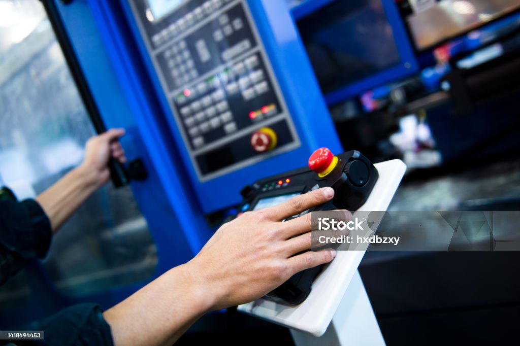 worker working with cnc machine at workshop. Accuracy Stock Photo