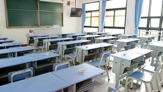 Empty classroom with chairs, desks.