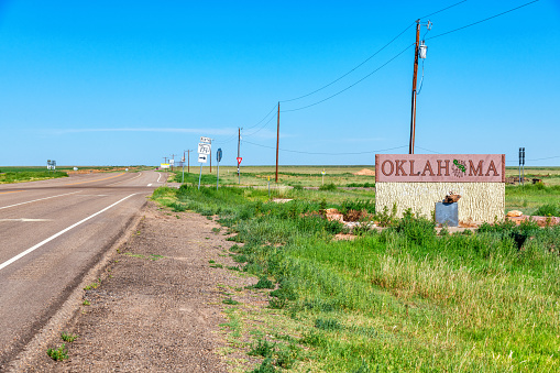 The sign at the Texas - Oklahoma border located in the panhandle of both states north of Amarillo.