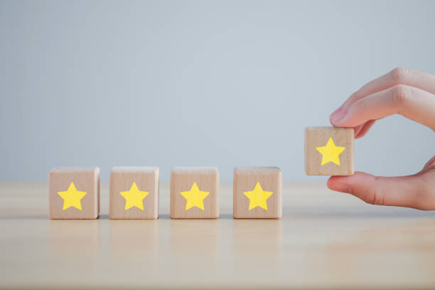 istock Evaluation, Satisfaction, Feedback, Review concept. Hand holding star to complete five star on wooden block to increase rating. The best excellent business services rating customer experience. 1418495680