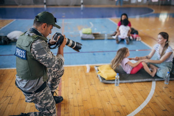 istock Army press with civilians after natural disaster 1418496642