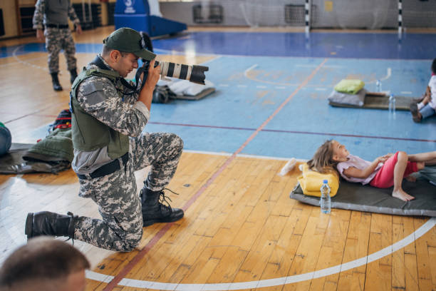 istock Army press with civilians after natural disaster 1418496665