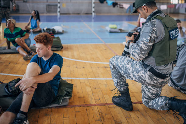istock Army press with civilians after natural disaster 1418496678