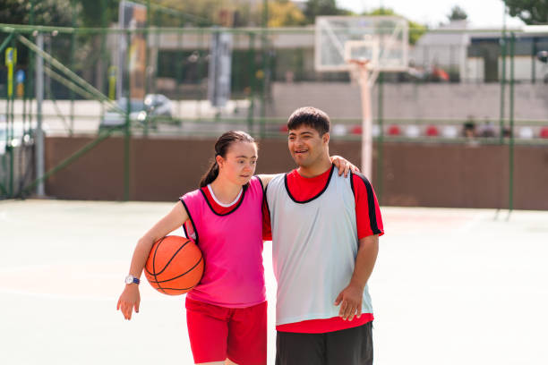 istock Young couple with down syndrome playing basketball 1418496908