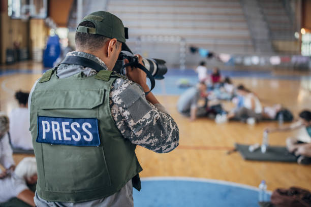 istock Army press with civilians after natural disaster 1418497621