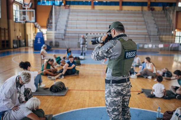 istock Army press with civilians after natural disaster 1418498142