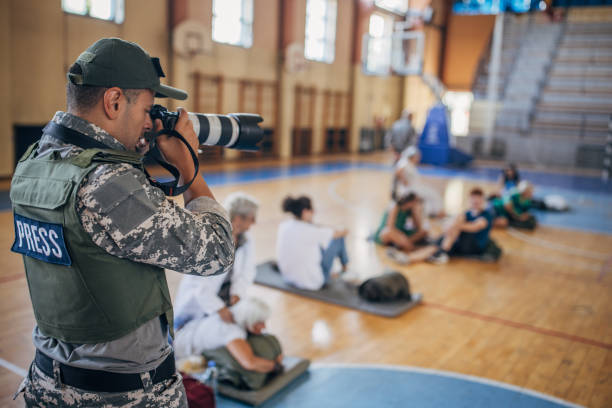 istock Army press with civilians after natural disaster 1418498154