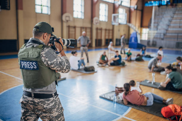 istock Army press with civilians after natural disaster 1418498191
