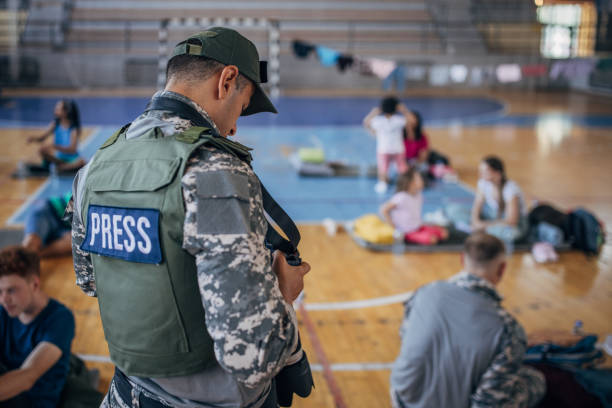 istock Army press with civilians after natural disaster 1418498240