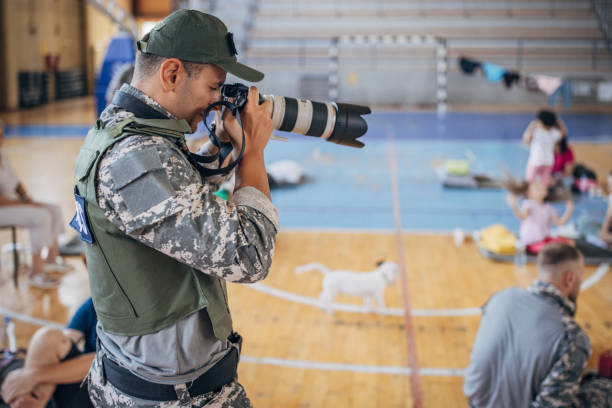 istock Army press with civilians after natural disaster 1418498290