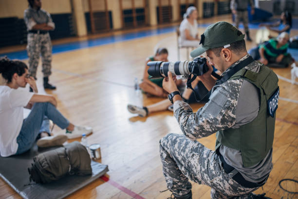 istock Army press with civilians after natural disaster 1418498359