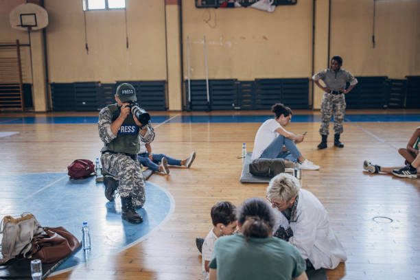 istock Army press with civilians after natural disaster 1418498507