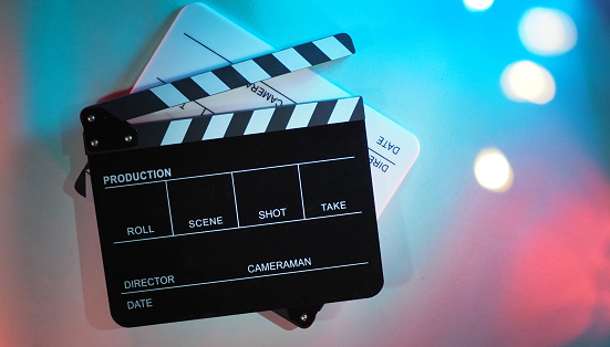 Black and white Clapperboard on multi-color background. Two Clapper board