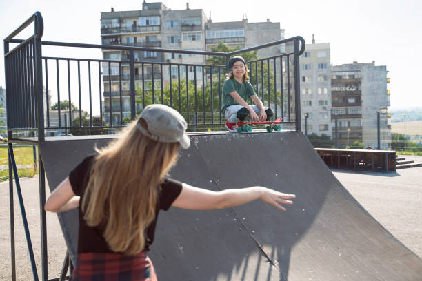 istock Mother and son having skateboarding training in skateboard park. 1418500624